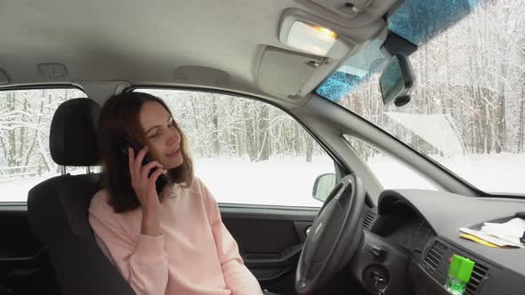 Closeup of Girl Lawyer Doctor Top Manager Sitting Behind While Driving a Car Winter Background alt
