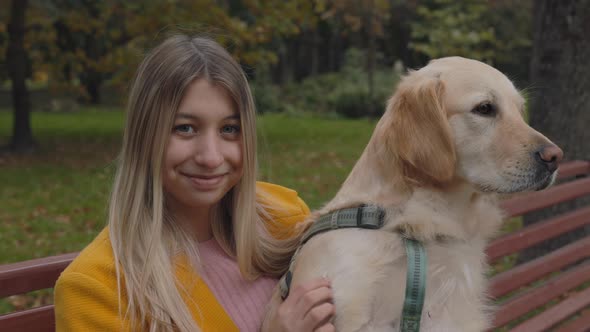 Portrait of Woman Sitting with French Retriever on Bench alt