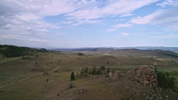 Baikal Valley spirits,Tazheran Steppe, Stone Cliffs on the Road. Aerial Summer alt