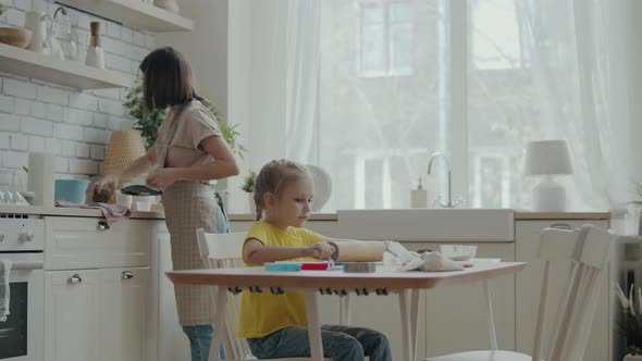 Mom and Child Cook in the Kitchen