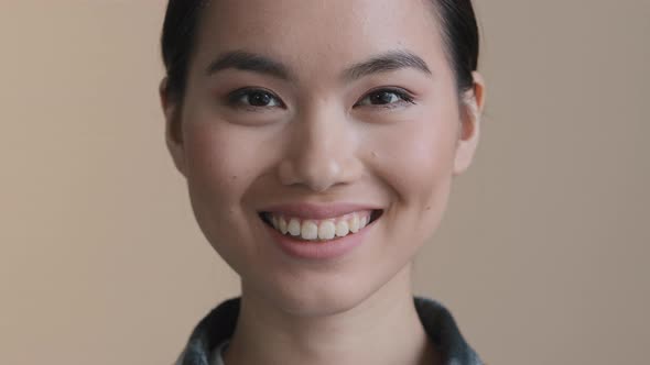 Head Shot Portrait Millennial Asian Businesswoman Smile Looks at Camera Pose in Office Room Home alt