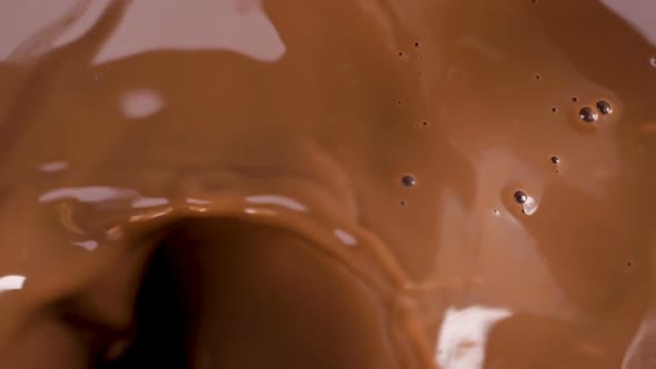 Chocolate Pieces Falling in Milk