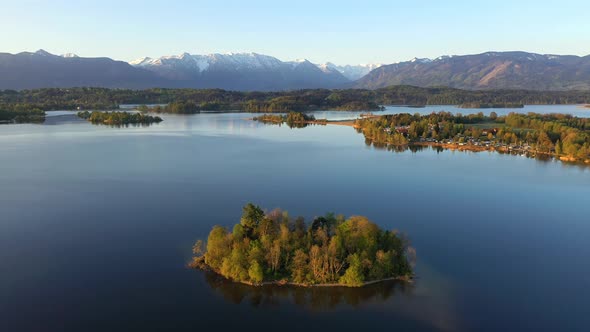 Flight over the island of Muhlworth in lake Staffelsee in Bavaria, Germany alt