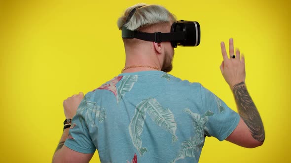 Man Using Virtual Reality Futuristic Technology VR Headset Helmet to Play Simulation 3D Video Game alt