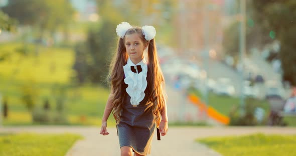 Portrait of a Schoolgirl Walking in the Park