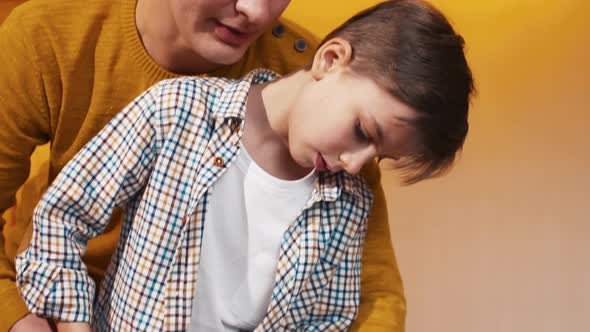 Father helping his son to keep screwdriver in hand