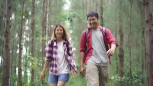 Hiker Asia backpacker couple on hiking adventure feeling freedom walk in forest their holidays. alt
