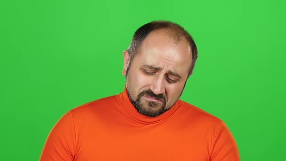Man with Overweight Eating a French Fries, He Does Not Want To Eat Fast Food, Green Screen. Slow alt