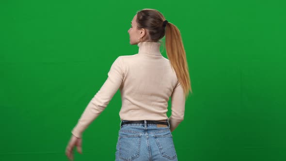 Slim Proud Woman Turning to Camera and Smiling Putting Hand on Hip alt