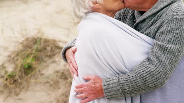 Senior man kissing senior woman alt