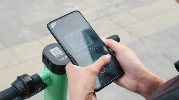 Woman Scan QR Code By Smart Phone to Unlock and Rent Electric Push Scooter on alt