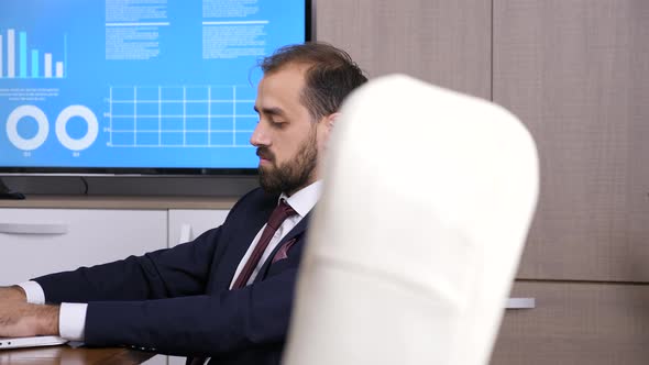 Businessman Working in Conference Room alt