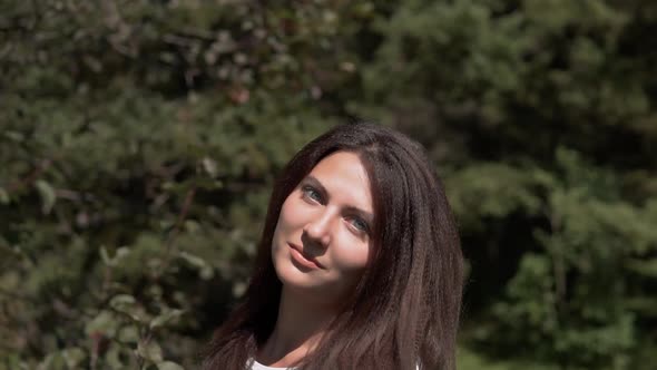 Attractive Girl Posing in the Park in Sunny Weather alt
