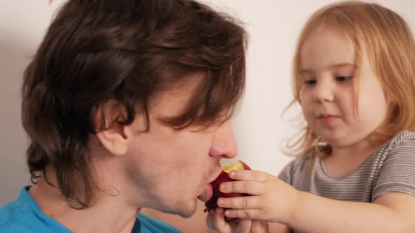 Little Girl Shares an Apple with Her Father Healthy Food Lifestyle