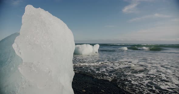 Crystal Ice Melting on Volcanic Beach in Diamond Beach on Iceland or Jokulsarlon. alt