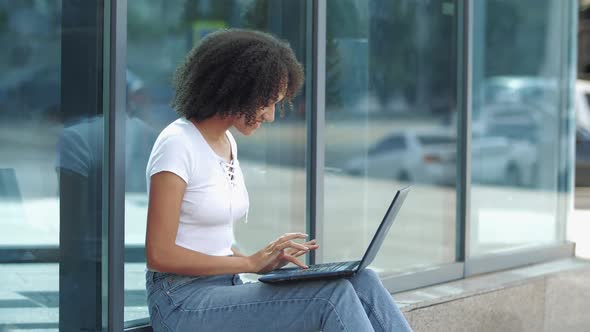 Excited Young African Shocked Woman Celebrating Success Getting Good News, Texting on Laptop, Waving alt