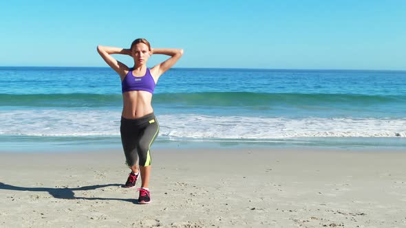Woman warming up on beach alt
