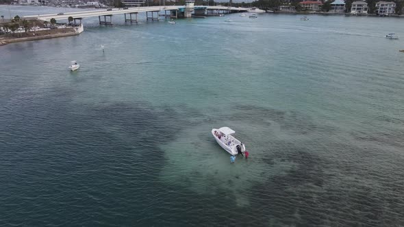 aerial of the boaters wading in the shallows of New Pass in Sarasota, Florida alt
