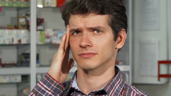 Young Man Having Headache Holding Pills 1080p alt