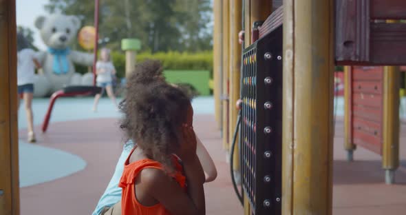 Multiethnic Happy Children Spend Free Time on Outdoors Playground alt