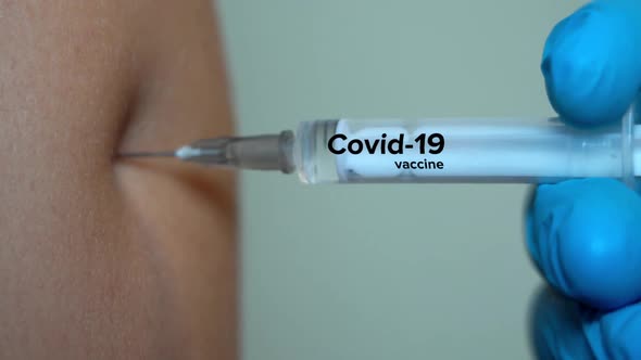 The Person Receives The Vaccine. The Syringe Vaccine Covid 19