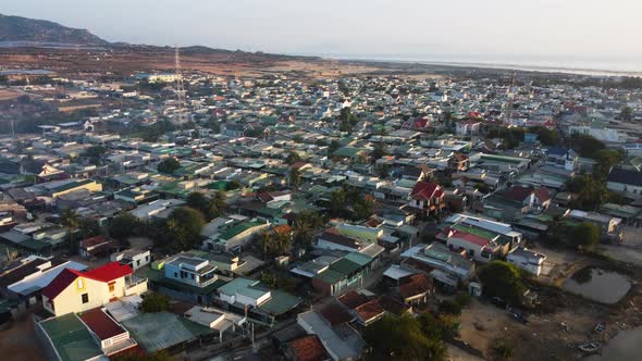 View of typical southern Vietnamese town near Phan Rang. Aerial flying forward alt