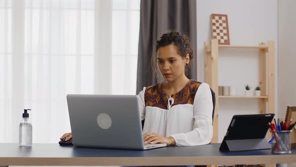 Business Woman Working on Laptop From Home Office alt