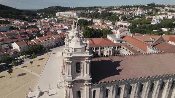 Details front facade of Alcobaca Monastery, gothic and baroque complex of building, aerial pan shot. alt