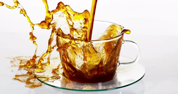 Coffee Being Poured in a Cup against White Background, Slow motion