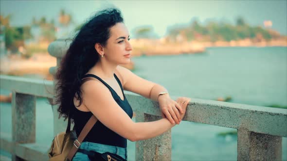 Wonderful Caucasian Woman Looking at Ocean View at Sunset. Young Beautiful Girl Enjoying Nature alt
