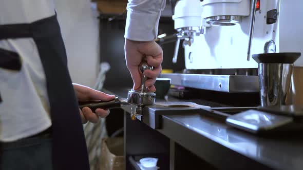 Male Barista Working with Ground Coffee While Standing in Kitchen of Cafe Spbas alt