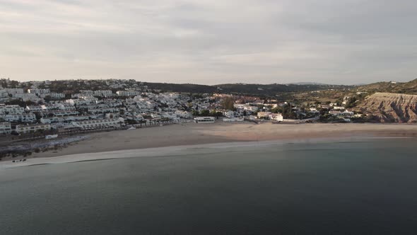 Wide View of Praia da Luz beach at dusk, Algarve, Portugal - Aerial alt