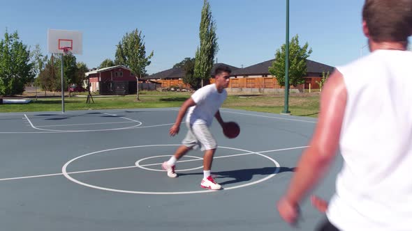 Friends playing basketball at park