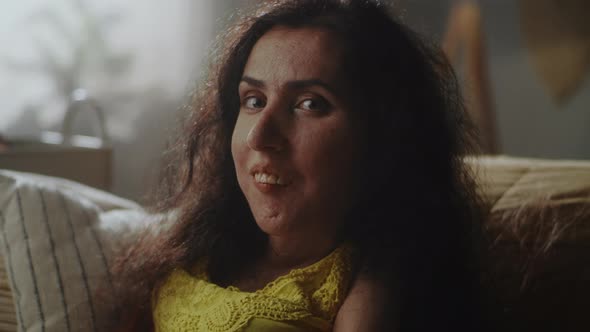 Woman with a Disability Smiling at the Camera alt