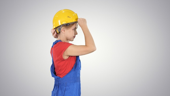 Young Happy Attractive Woman in Construction Uniform Putting alt