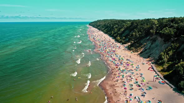 Crowded beach with people at Baltic Sea in summer alt
