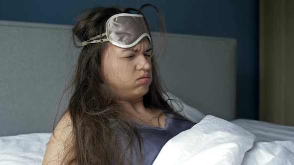 Young Woman Waking Up Suffering Headache and Hangover After Drinking Alcohol