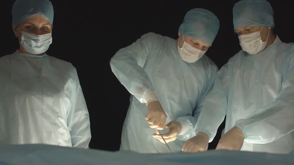 Three Surgeons, a Man and a Woman, Perform Surgery To Remove Prostate Adenoma and Varicocele alt