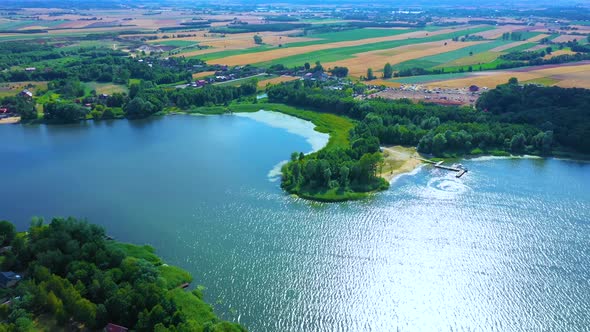 Epic Top Down Aerial View of Big Lake With Clear Blue Water. Reflection of Sky in Clear Lake in Even alt