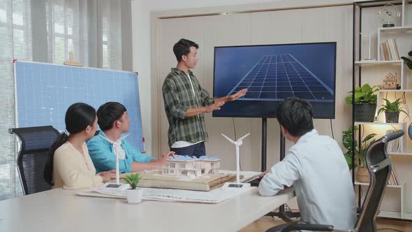 Asian Man Engineer Presenting About The Work Of Solar Cell To His Colleagues At The Office alt