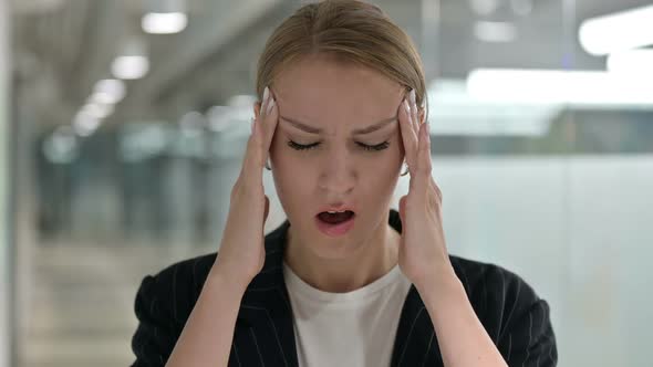 Exhausted Young Businesswoman Having Headache alt