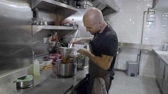 Half Body Side View of Male Chef Working in Restaurant Kitchen alt