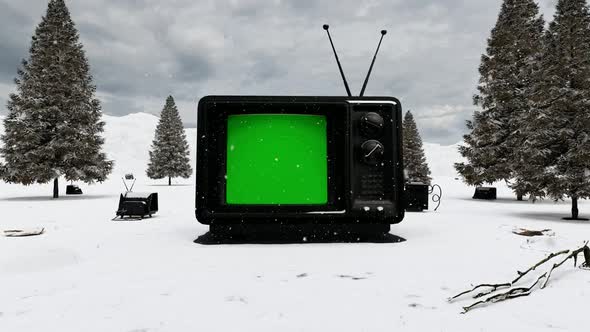 Old Black TV Standing on the Ground in the Snowy