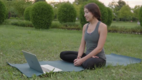 Consultation Yoga Video Lesson Sports Woman Instructor Teaches Yoga to Students in Front of a Laptop