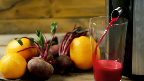 Juice maker pouring juice into glass 4k alt