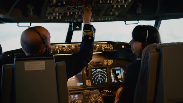 Plane Captain and Female Copilot Switching Altitude and Longitude Level alt
