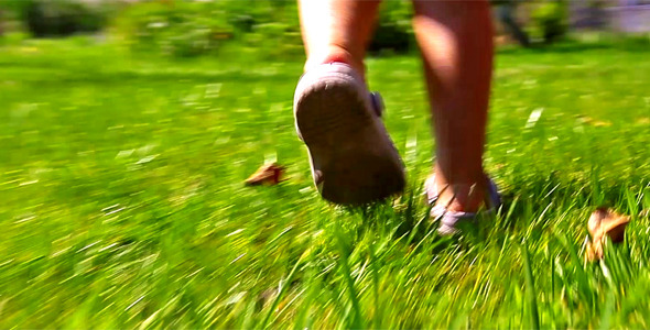 Girl Running On Green Grass