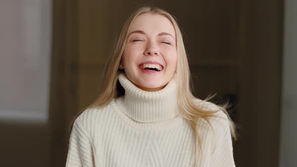 Portrait of Happy Beautiful Blonde Millennial Girl Standing Indoors Looking at Camera with White alt