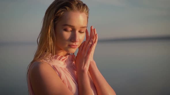 Young Tender Girl in the Water Against the Background of Dawn. Sexy Girl on the Beach. Young Woman alt