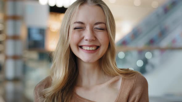 Attractive Caucasian Girl with Long Blonde Hair Points Fingers at Camera Smiles Toothy Happy you are alt